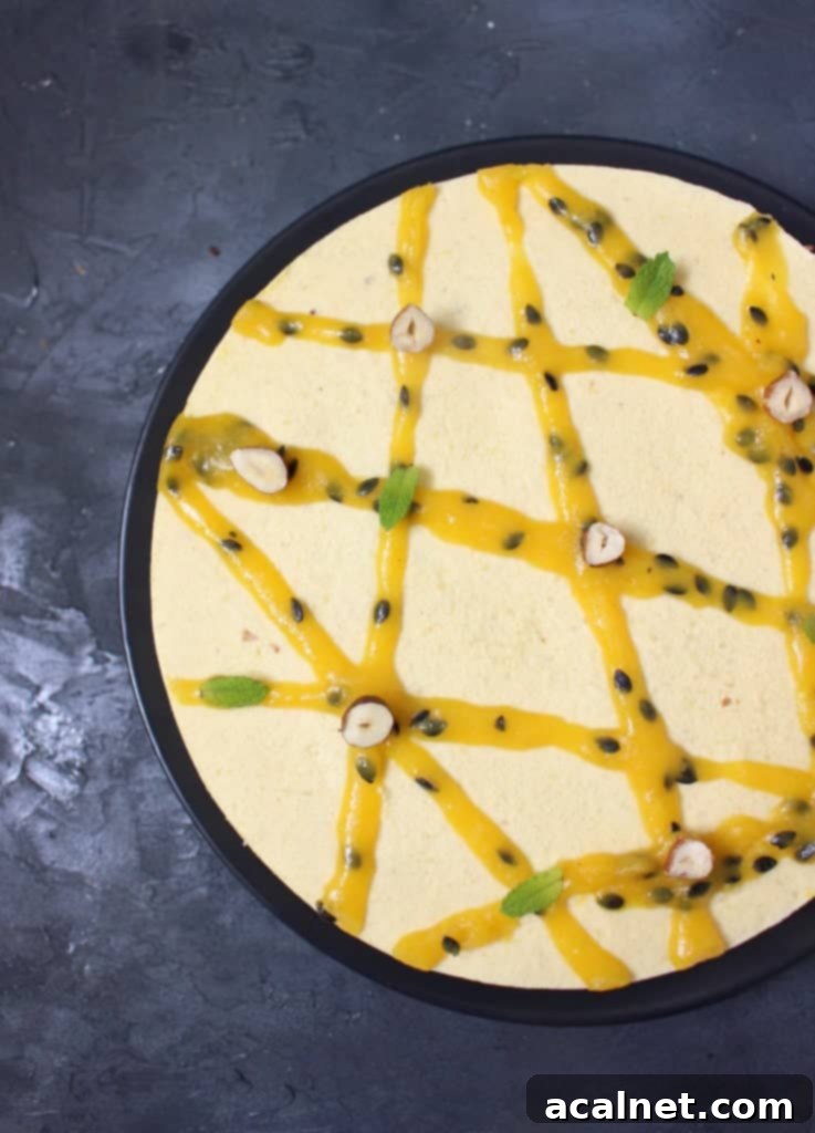 Vegan No-Bake Mango Cheesecake 5 Half of the dessert from above with view on the intricate glaze pattern and vibrant colors