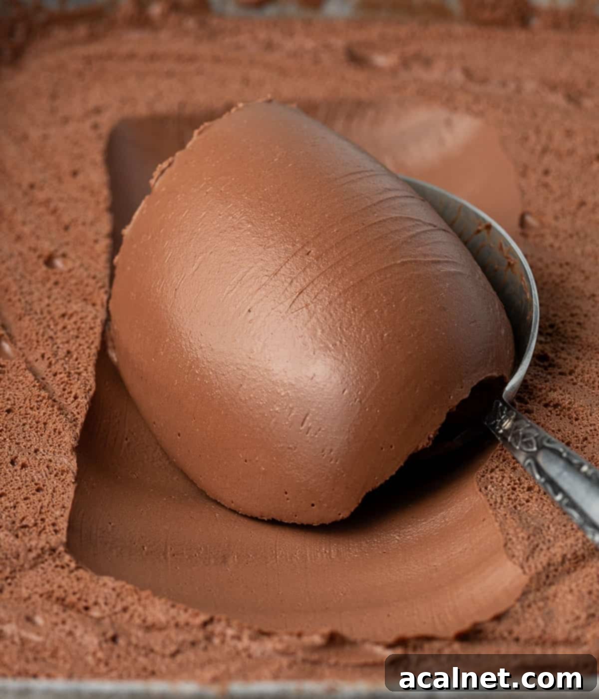 Close up on some cream scooped over a spoon.