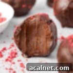 Close up on a truffle with a bite taken off.