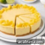 Tropical Mango Mousse Cake 11 A beautifully presented mango mousse cake on a white plate with three slices cut out, showcasing its distinct layers.