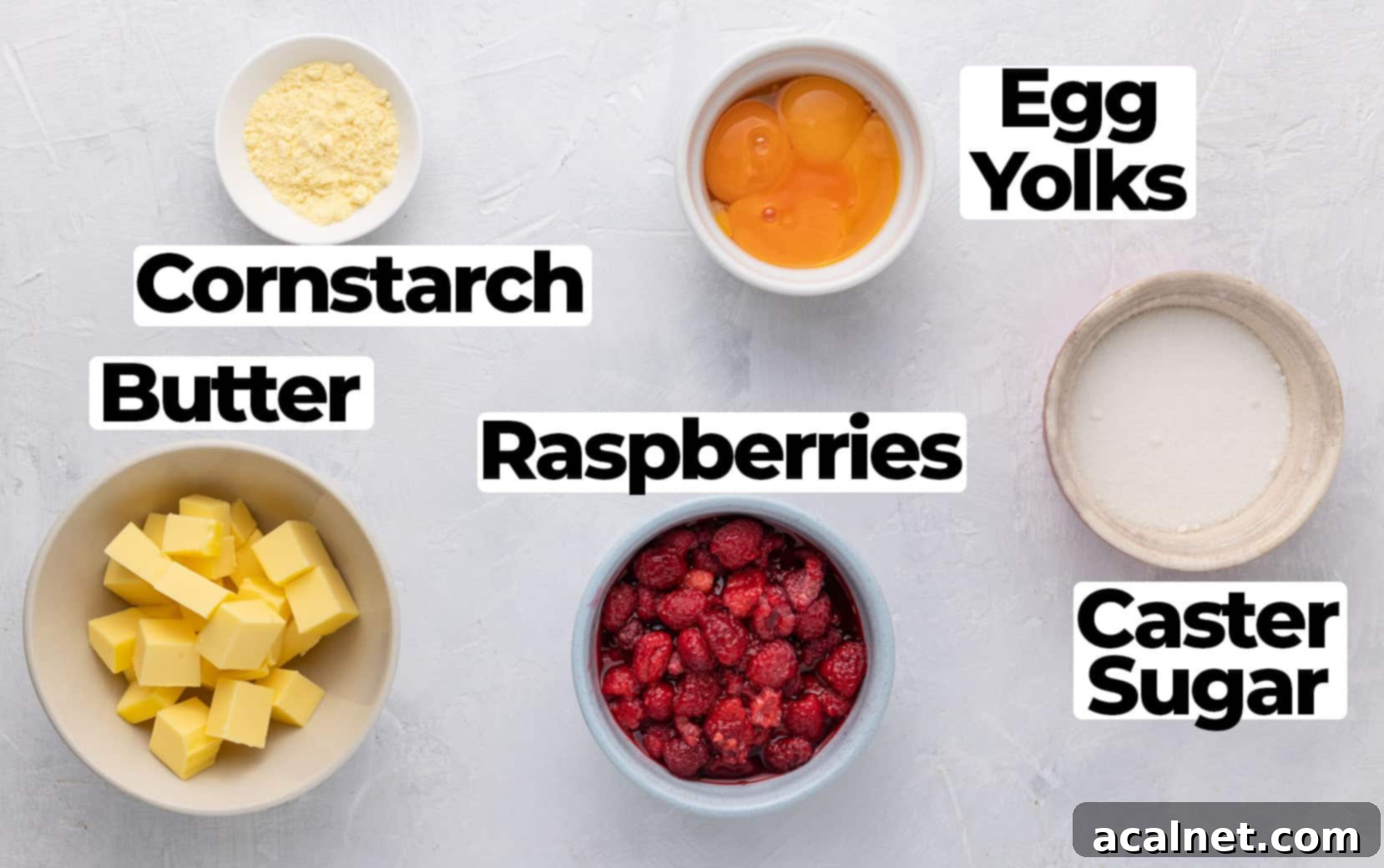 Fresh ingredients for raspberry curd laid out on a clean white surface.