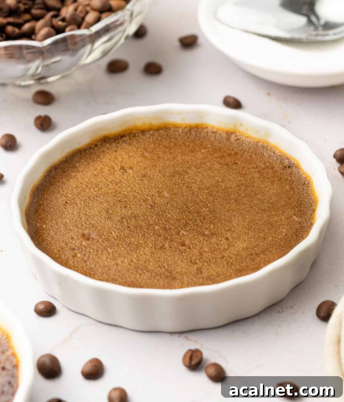 Baked coffee custard in a white ramekin.