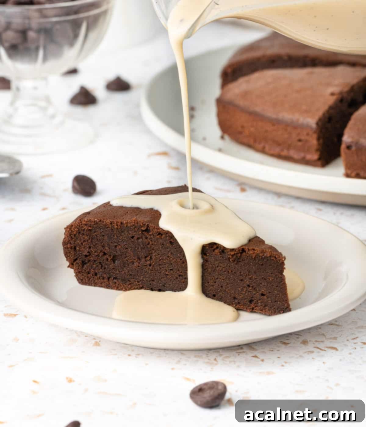Pouring the custard over a slice of chocolate cake.