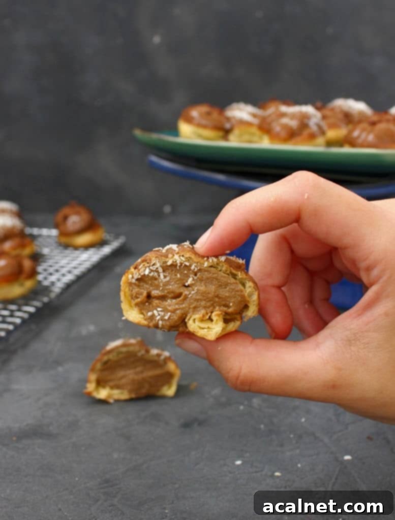 Close-up of a filled Coffee Choux Bun with the pastry cream visible