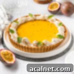 A beautifully crafted Passion Fruit Tart on a pristine white plate, surrounded by halved fresh passion fruits. This image serves as a visual guide and mouth-watering representation of the final dessert.