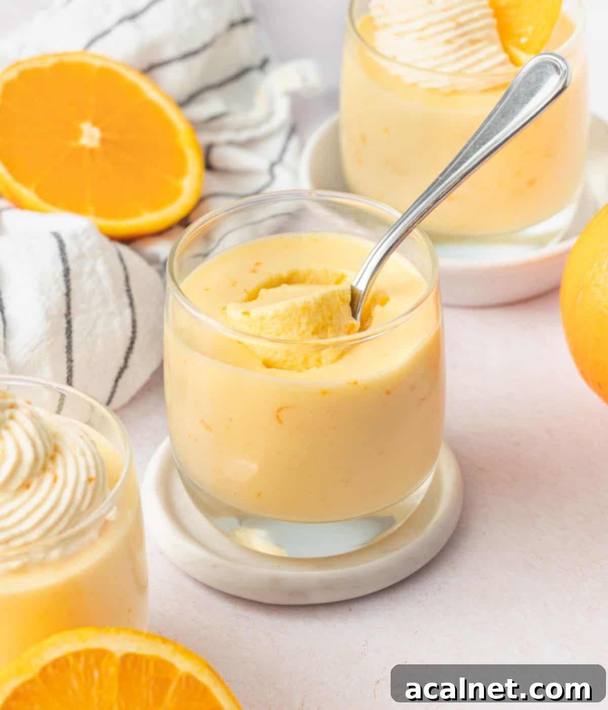 Zesty Orange Mousse Cups 8 Taking a spoonful of mousse out of the cup.