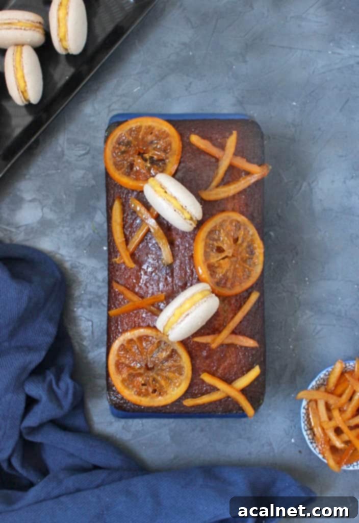 Honey Loaf from above topped with candied oranges and macarons