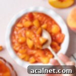 Simple Berry Coulis 9 Compote in a small white bowl with a sliver spoon - seen from above