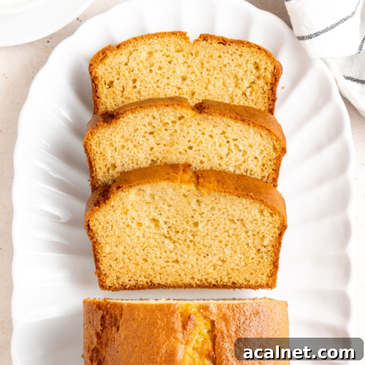Stack of 3 slices of cake seen from above on an oval white plate.