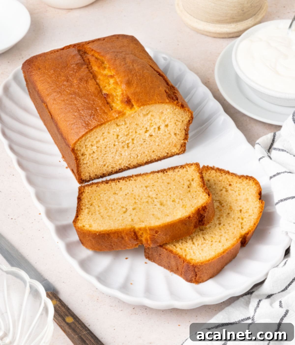 Cake on a white tray with two slices stacked at the front.