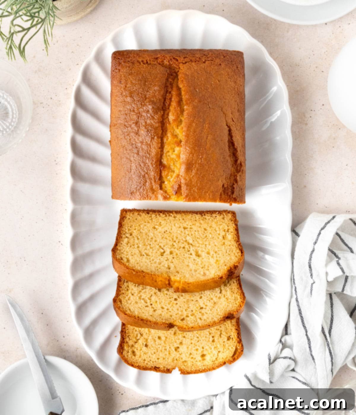 Loaf seen from above on an oval tray with 3 slices cut out.