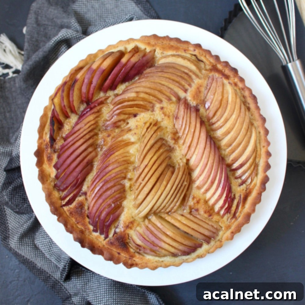 Peach Frangipane Tart from above on a white stand.