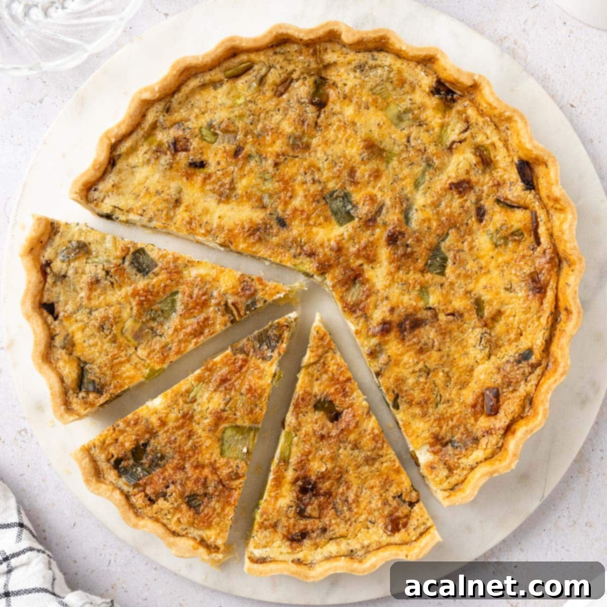 Close up on the quiche seen from above with 3 slices cut out.