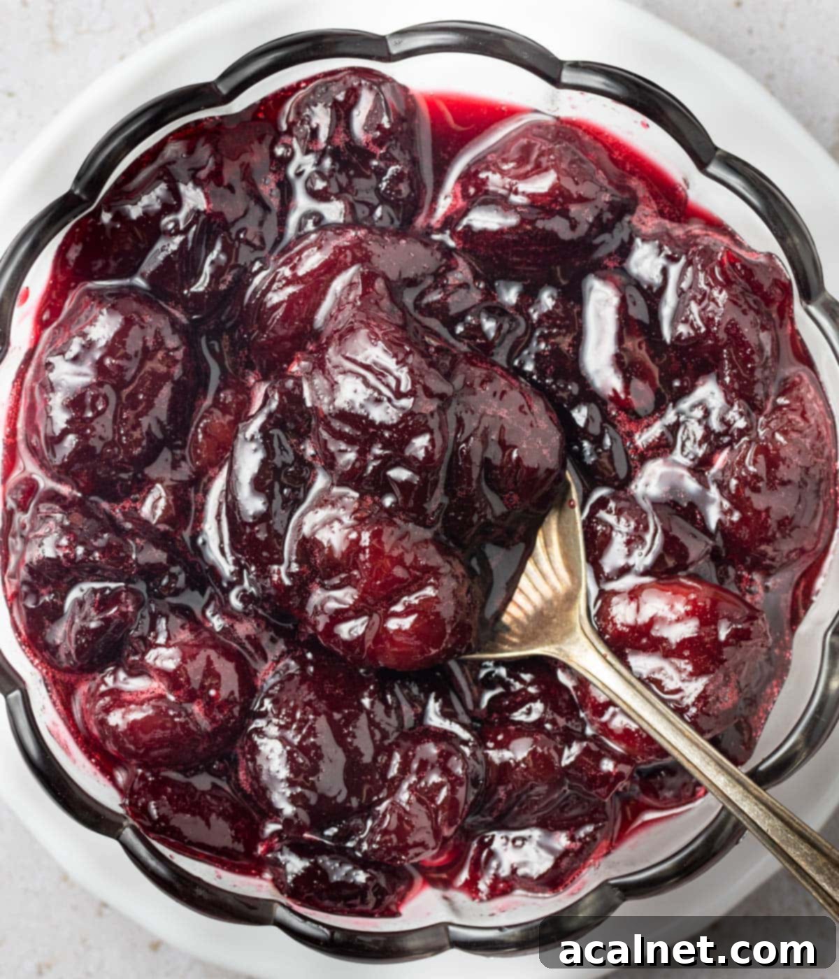 Close up on the cherry sauce seen from above in a glass bowl.