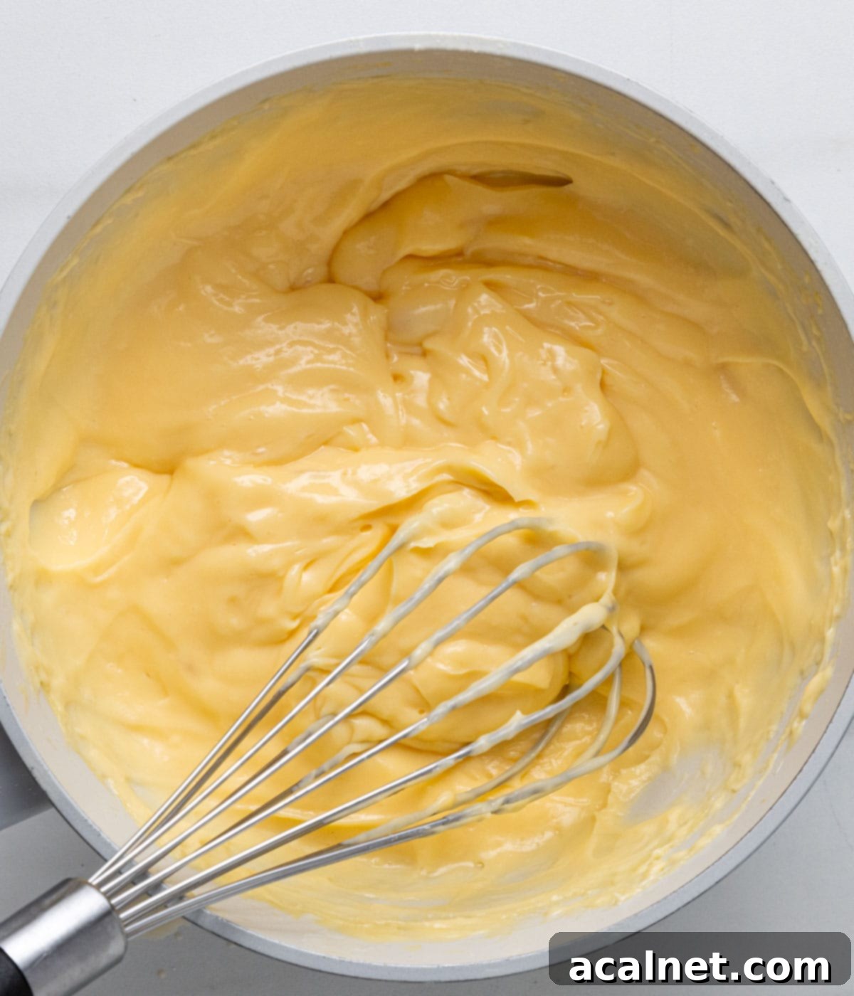 Velvety Praline Mousseline 5 Process shot: cooking the pastry cream in a saucepan until thick and then cooling it in a wide dish.