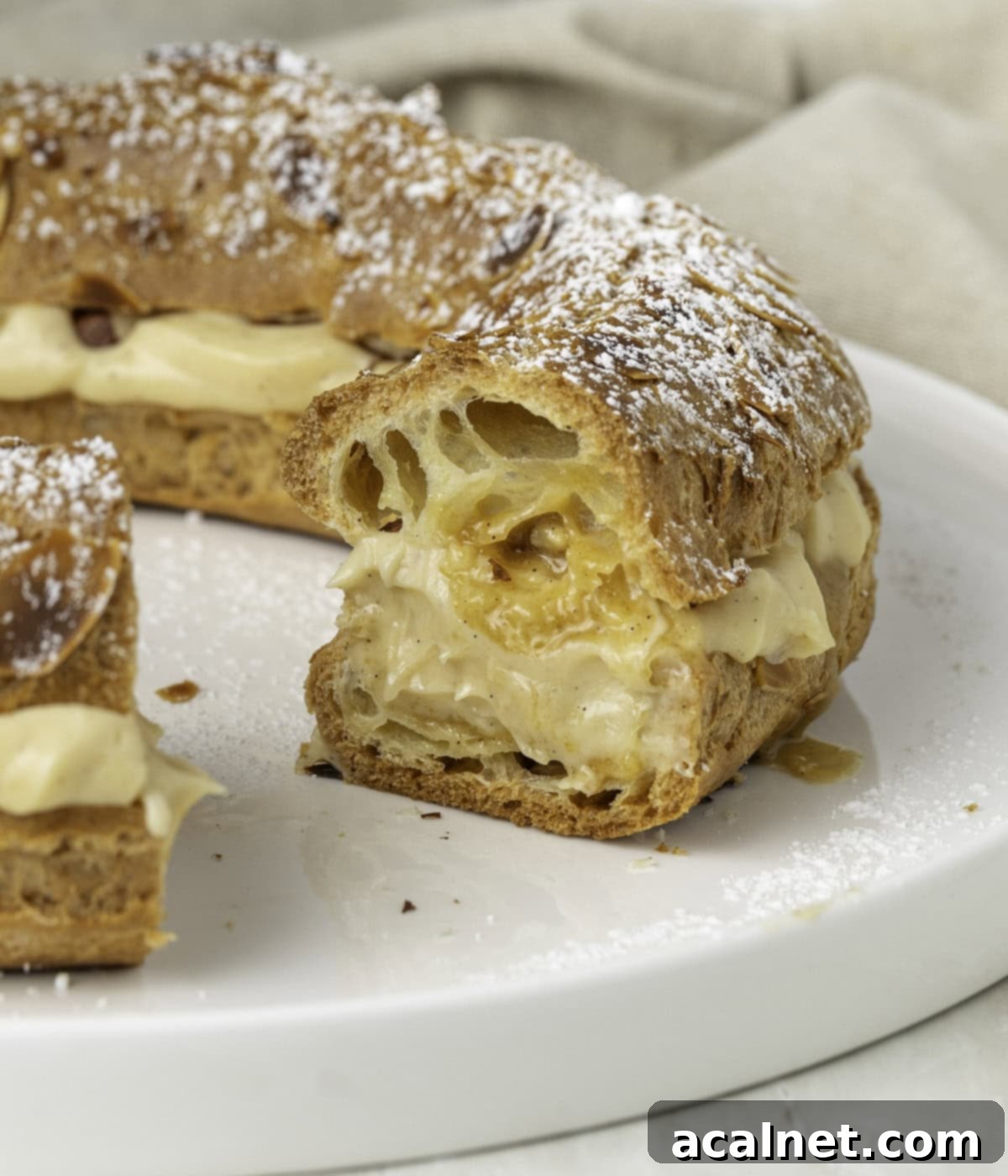 Velvety Praline Mousseline 9 Praline cream generously piped inside a beautifully crafted Paris-Brest Cake, ready to be served.