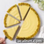 Pistachio tart seen from above with 4 slices cut off.