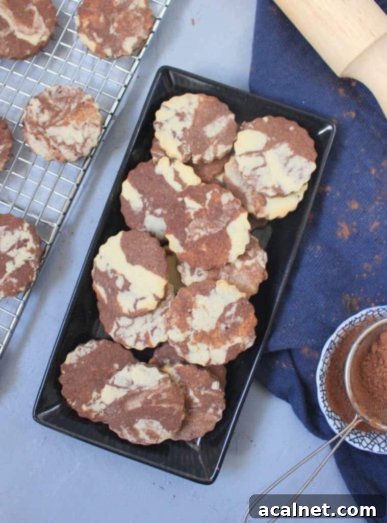 Cookies on a rectangular black plate from above, showcasing the beautiful swirl of vanilla and chocolate dough.