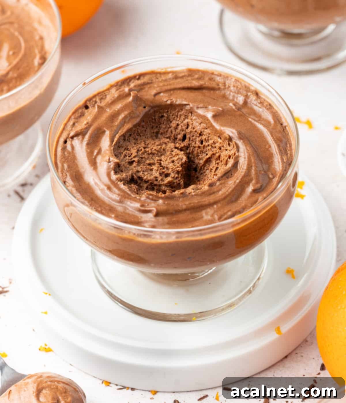 15+ Decadent Mousse Delights 4 Spoonful of rich chocolate orange mousse being lifted from a glass cup, perfectly showcasing its smooth and aerated texture.