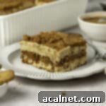 Close up on a slice of speculoos tiramisu on a small white plate, showing the layers.