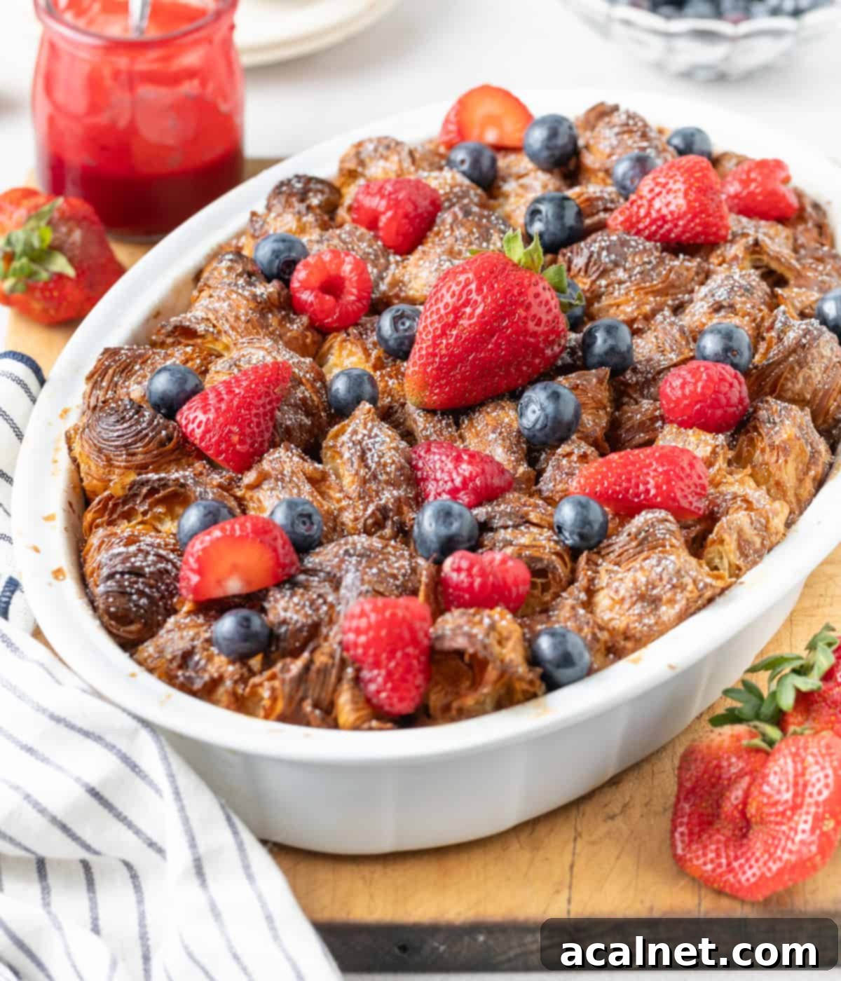 45 degrees view on the dish topped with fresh berries and icing sugar.