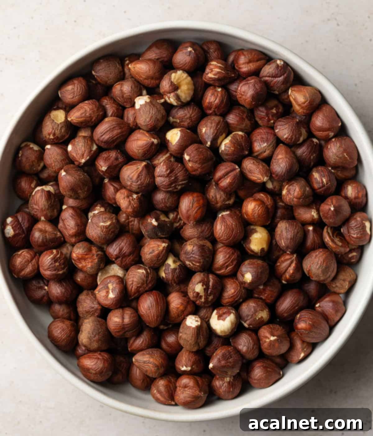 Crafting Homemade Hazelnut Butter 3 Raw hazelnuts in a bowl seen from above.