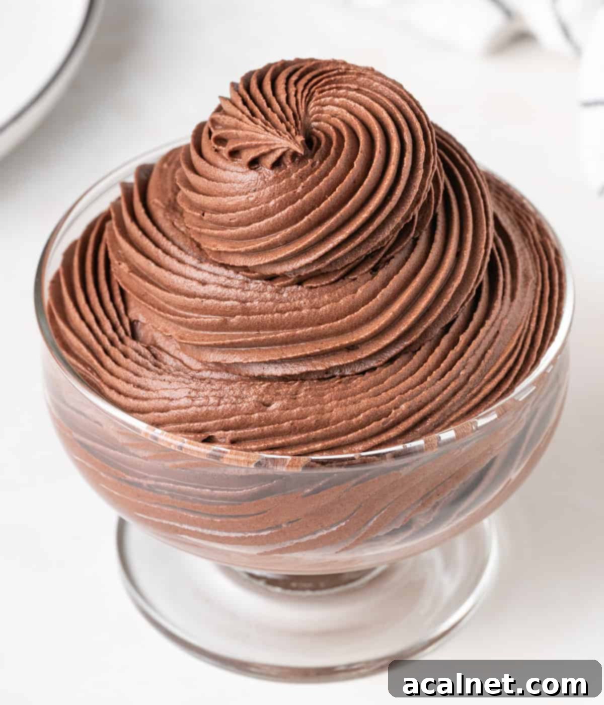 Chocolate Cloud Frosting 7 Cream pipped inside a glass dessert cup.