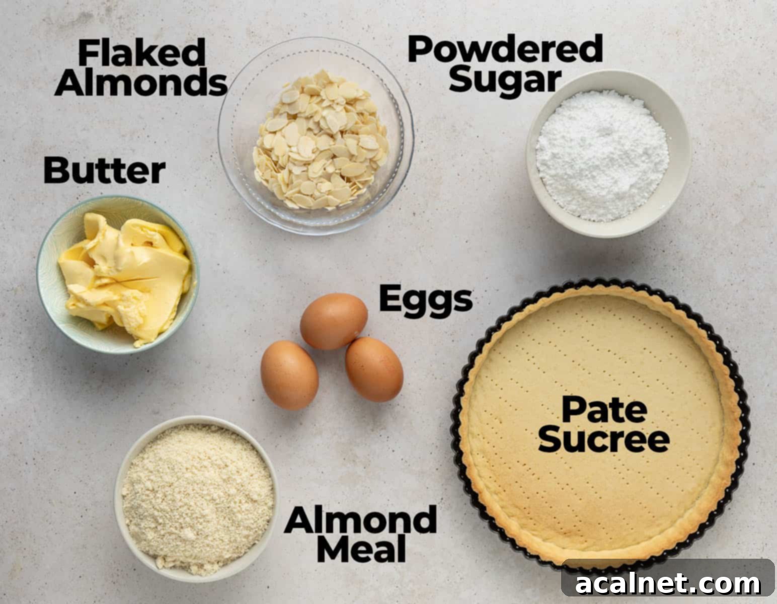 Ingredients for French Almond Tart, neatly arranged on a light beige surface.