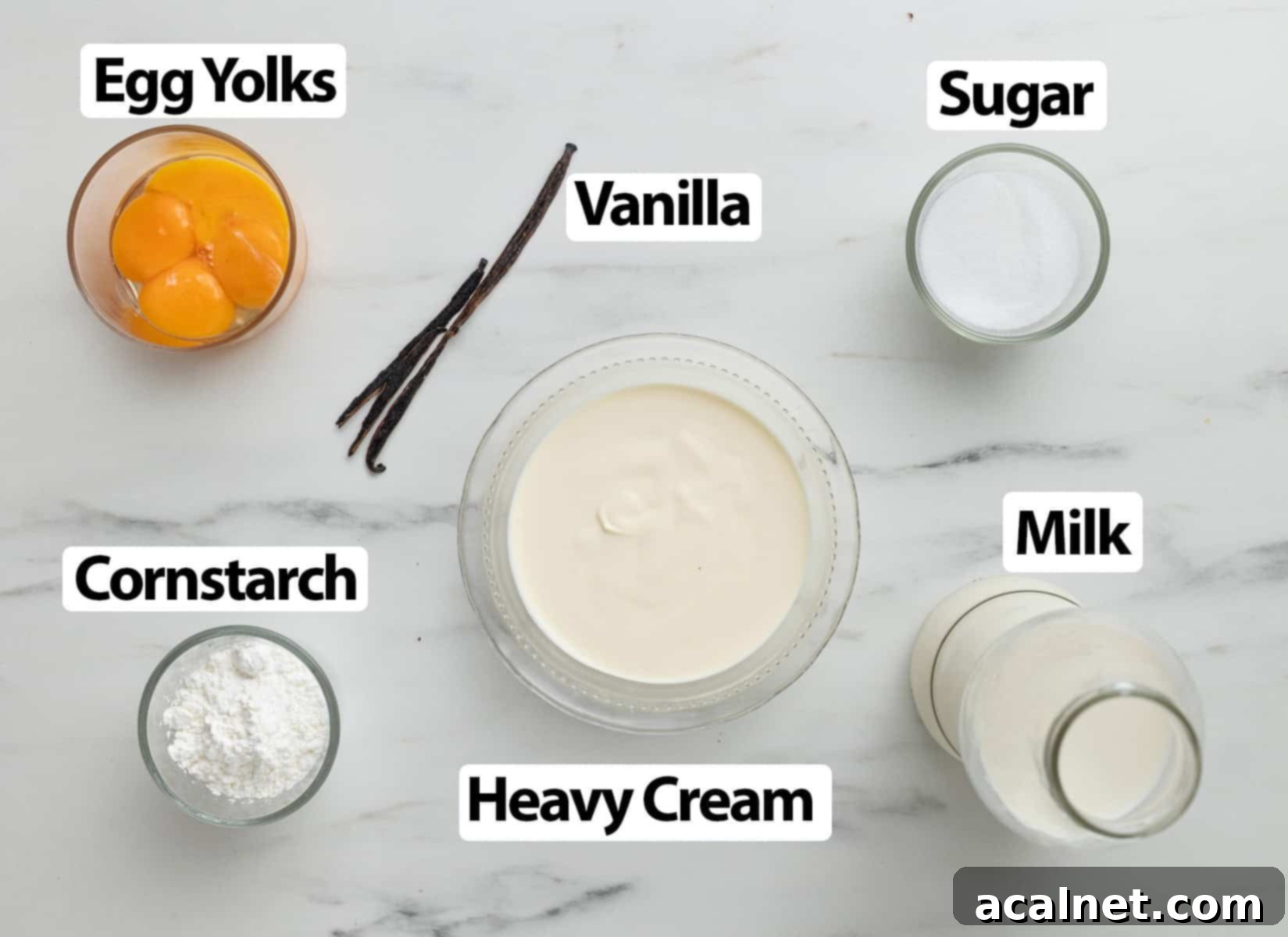 Light Pastry Cream 3 A selection of fresh ingredients including milk, vanilla bean, eggs, sugar, cornstarch, and heavy cream, neatly arranged on a marble surface.