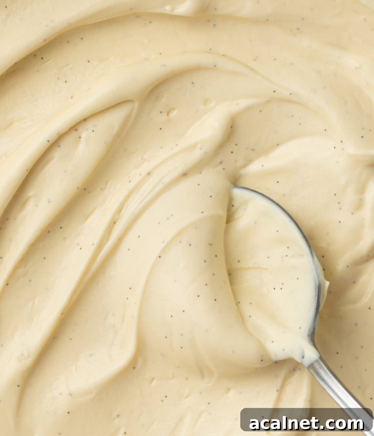 Light Pastry Cream 6 Close-up view of Crème Légère swirled in a bowl with a spoon, seen from above, highlighting its smooth and luxurious texture.