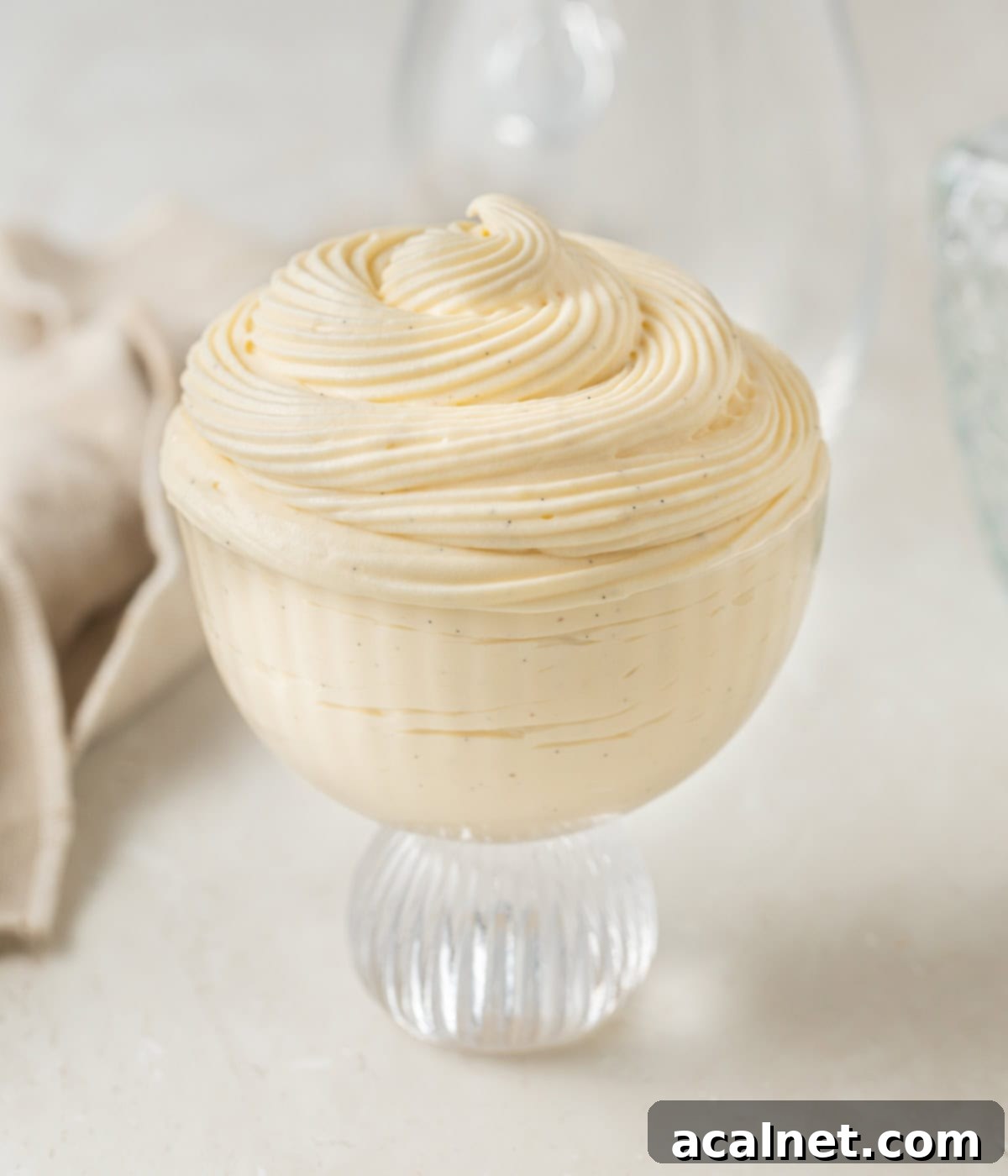 Light Pastry Cream 8 Creamy Crème Légère piped into a clear glass dessert cup, ready for serving or adding toppings.