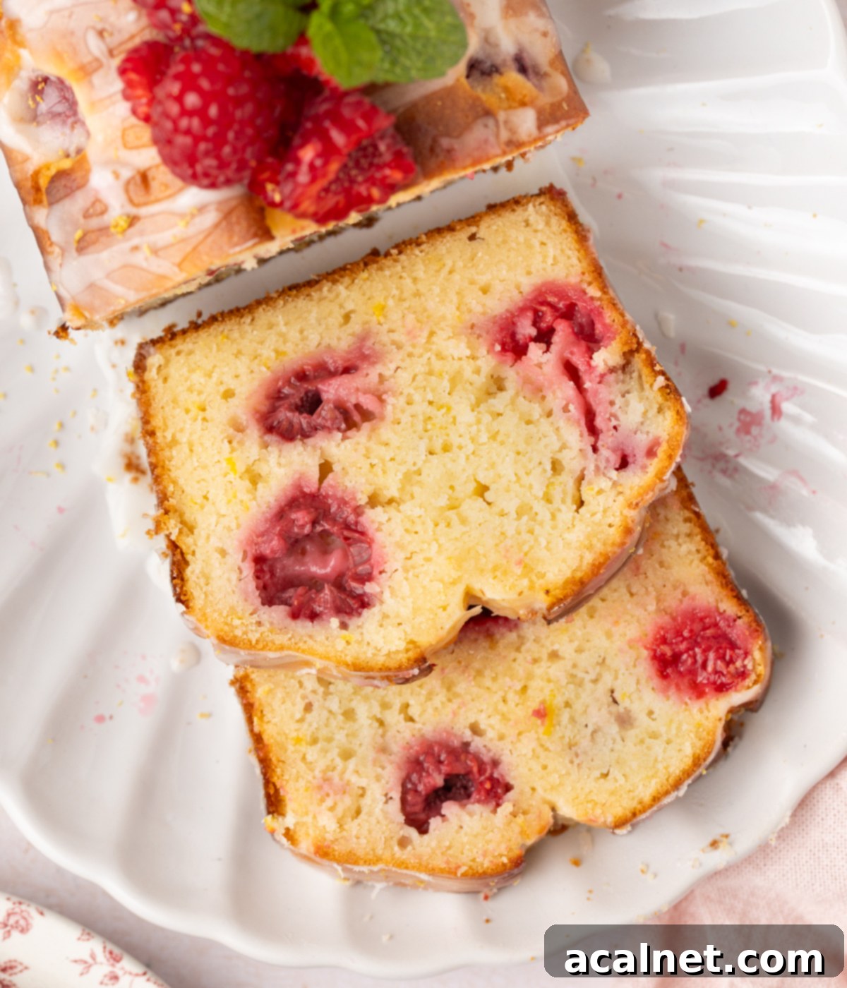 Zesty Lemon Raspberry Loaf 7 Close up on a slice of loaf cake seen from above.