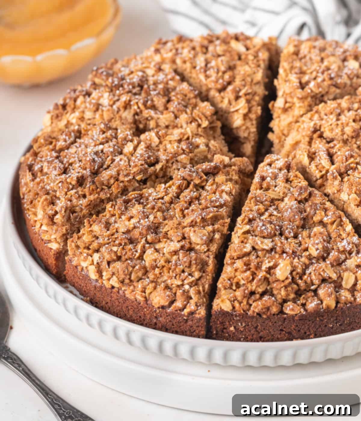 Cake sliced into 8 pieces on a large white plate.
