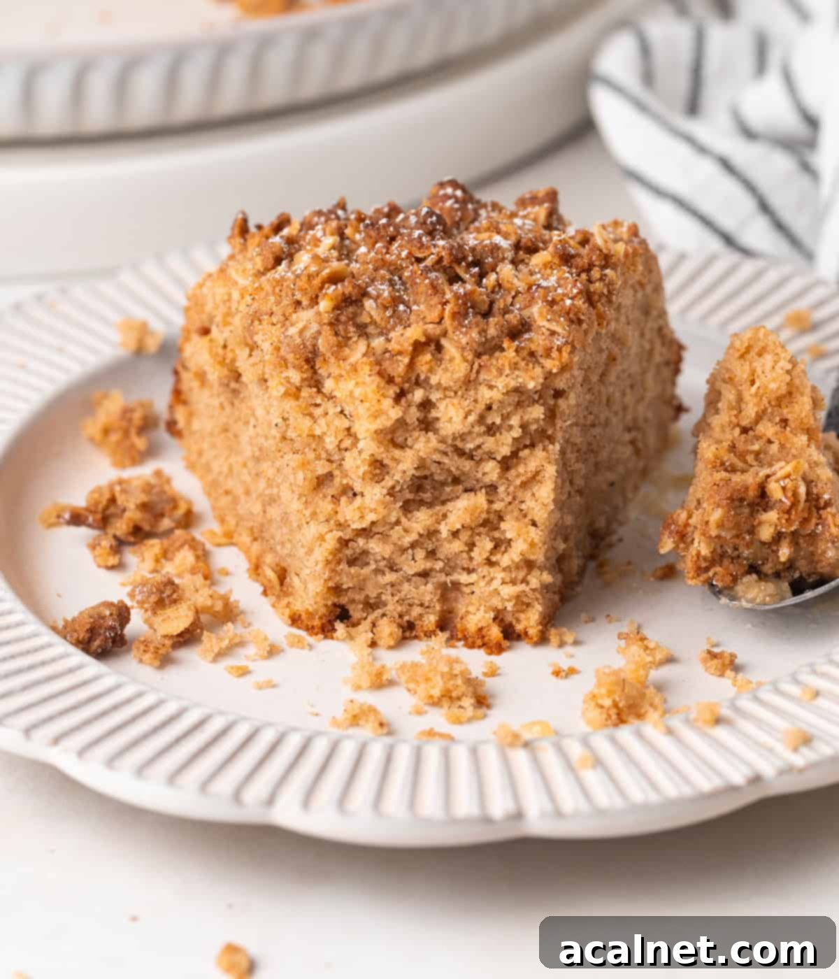 Close up on a cake slice with a bite taken off.