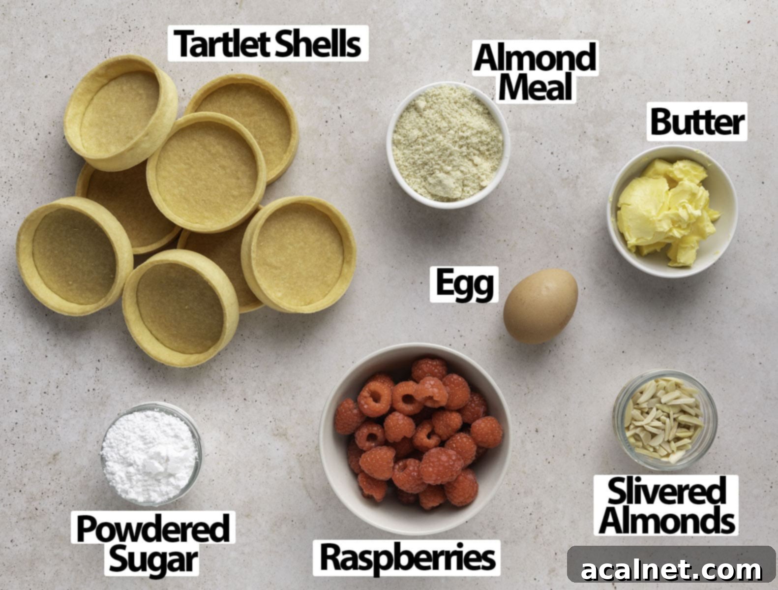Ruby Raspberry Almond Tarts 3 Ingredients laid on a light beige surface.