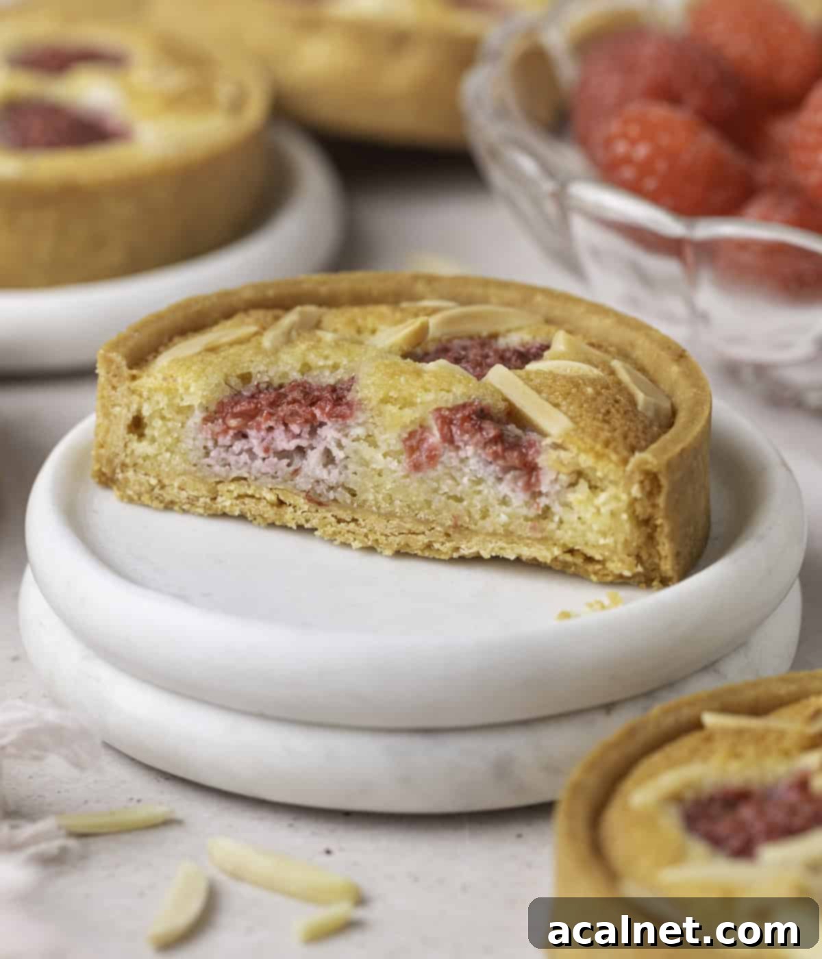 Ruby Raspberry Almond Tarts 10 Tart sliced in half with focus on the inside of the tart.