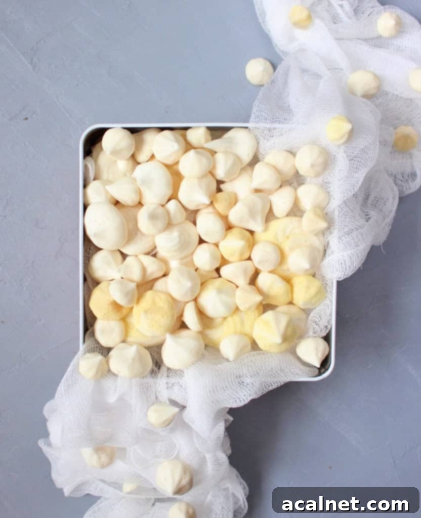 Close-up of freshly piped Eggless Meringues Cookies on a baking tray, ready for the oven