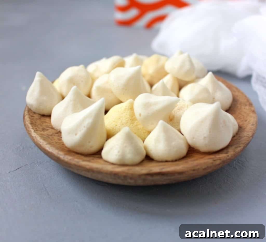 Various shapes of No Eggs Meringues Kisses, some colored yellow, arranged beautifully