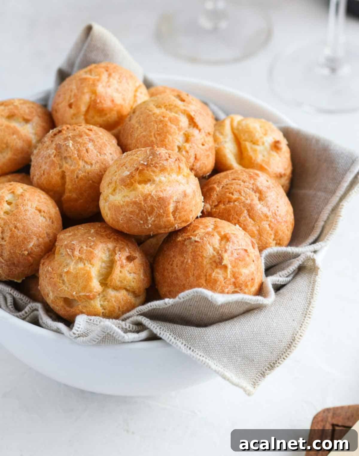 Close up on the cheese puffs inside a white bowl.