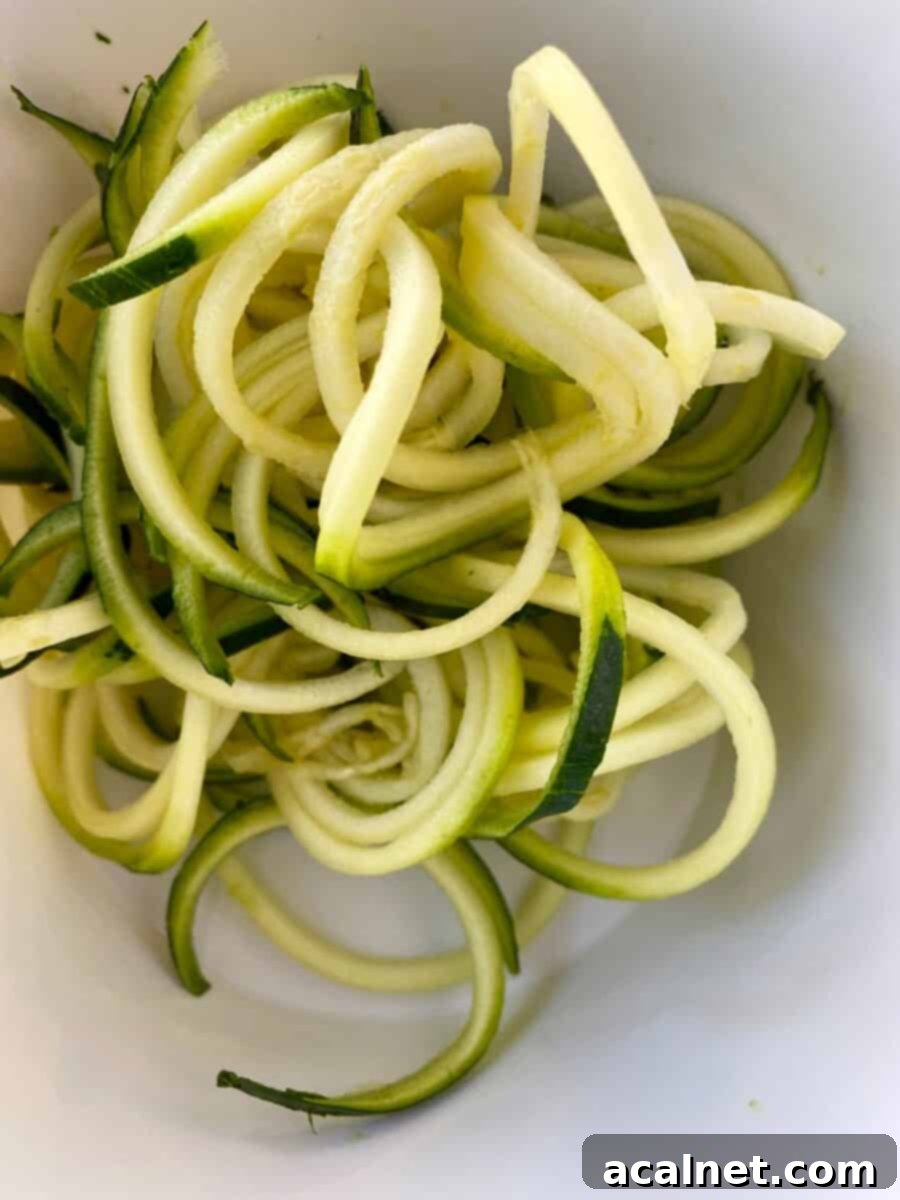 Curled zucchini noodles in a bowl.