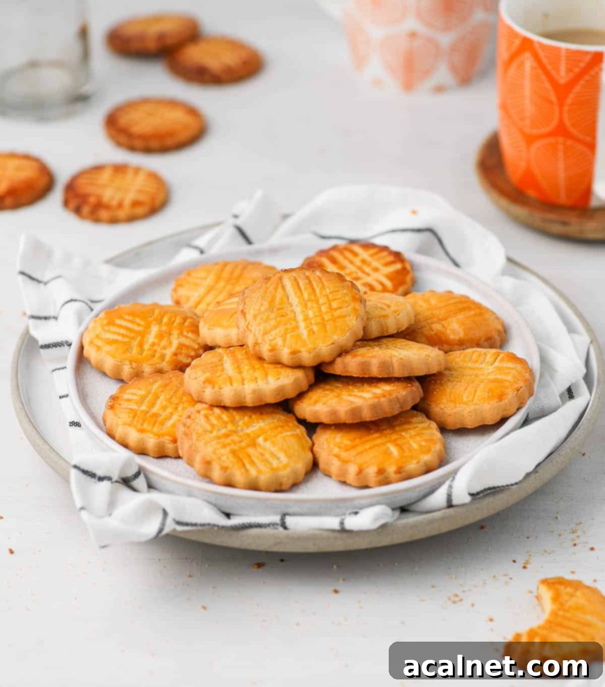 Buttery Breton Cookie Delights 8 Sablés Bretons Cookies presented on two white plates with a white tea towel, ready to be enjoyed.