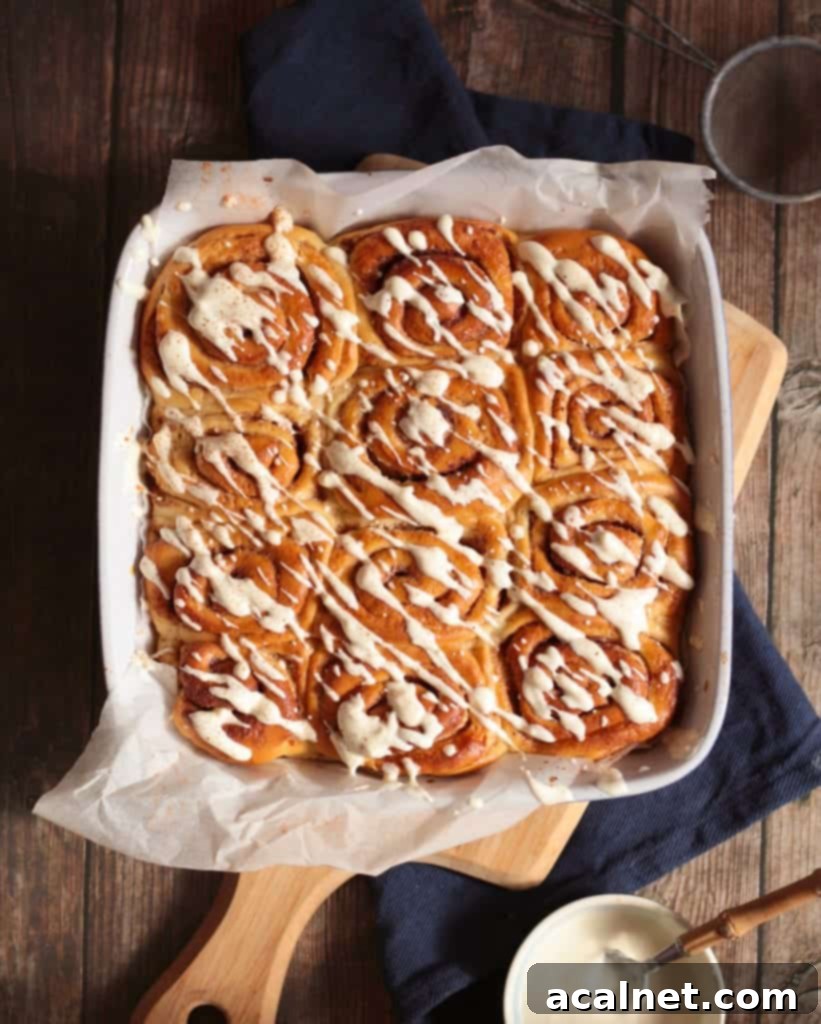 Scrolls in the baking pan from above topped with Yogurt Icing