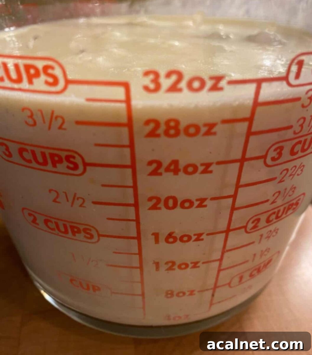 Liquid ingredients for Starbucks copycat egg bites, blended and ready to pour, in a measuring cup.