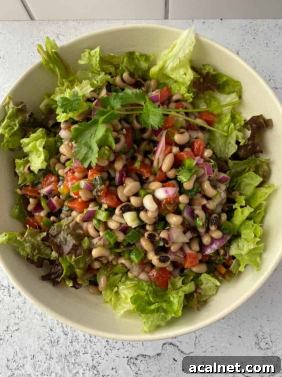 Close-up of black-eyed peas in a bowl, showing their distinct black 'eyes', ready to be incorporated into a fresh salad.