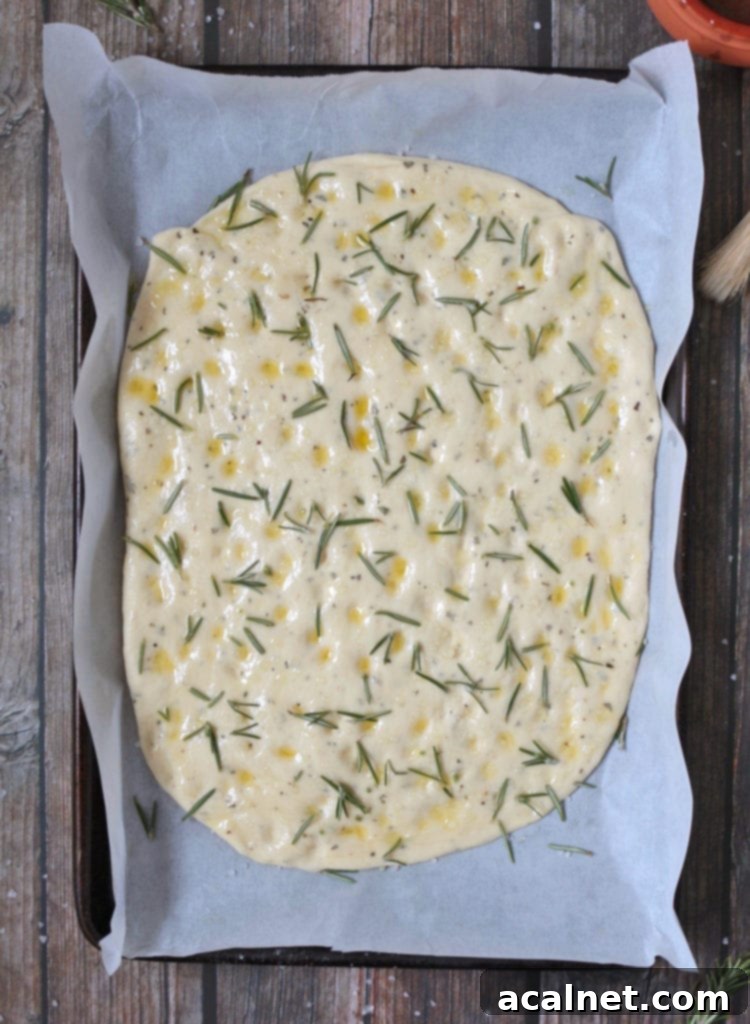 Effortless Rosemary Focaccia Perfection 5 Uncooked Focaccia Bread, ready to go in the oven.