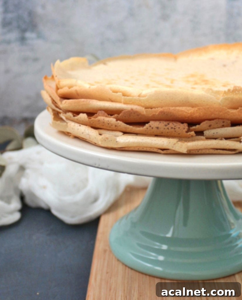 Close-up shot of the thin, perfectly cooked French Buckwheat Crêpes, showing their texture and inviting dark color.