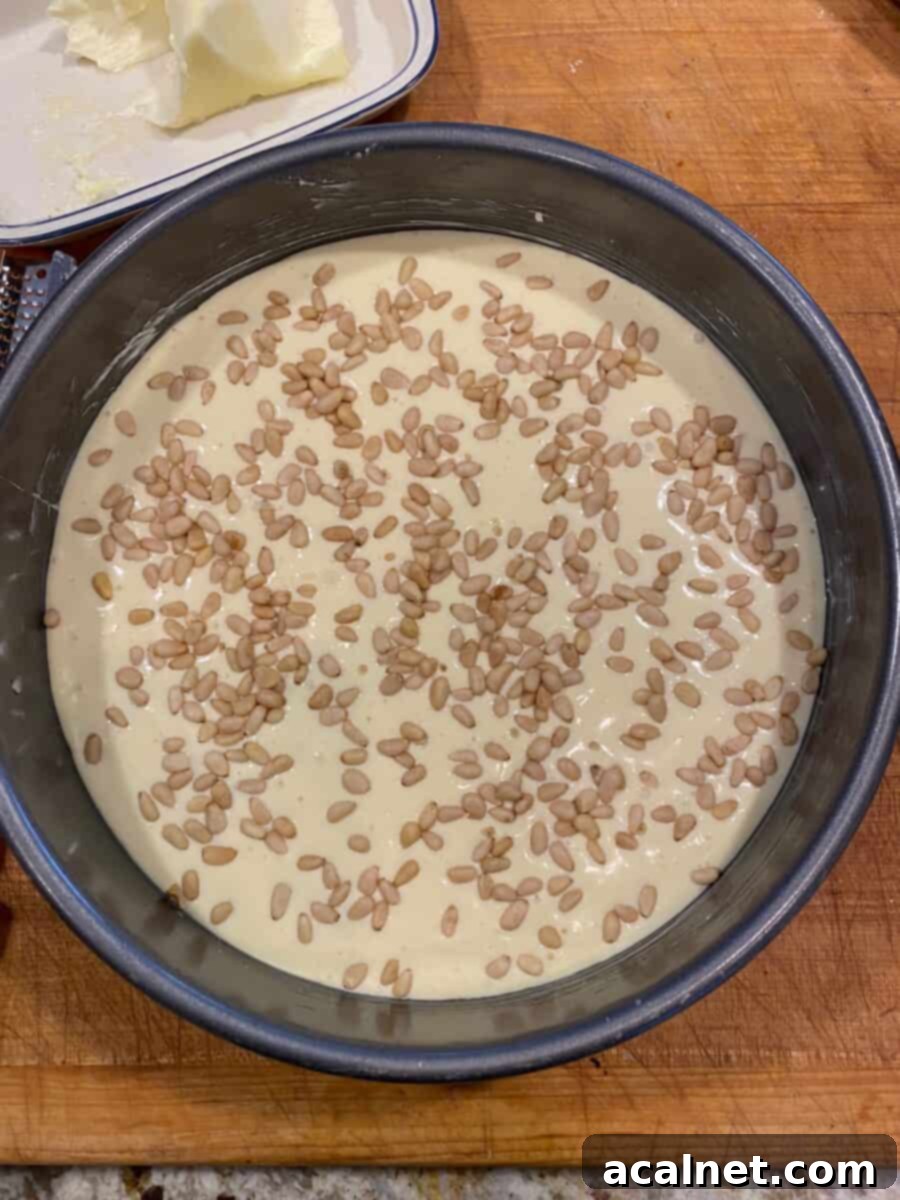 Cheesecake top with pine nuts sprinkled in the batter.