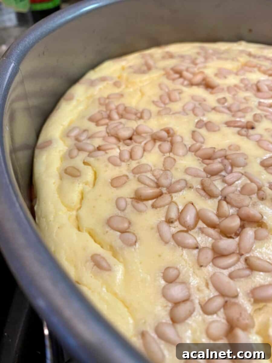 Side view of the cheesecake with small cracks around the edges.