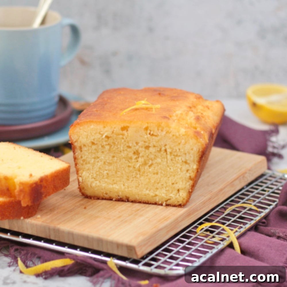 Sliced Lemon Drizzle Loaf, showcasing a moist crumb and glistening lemon icing