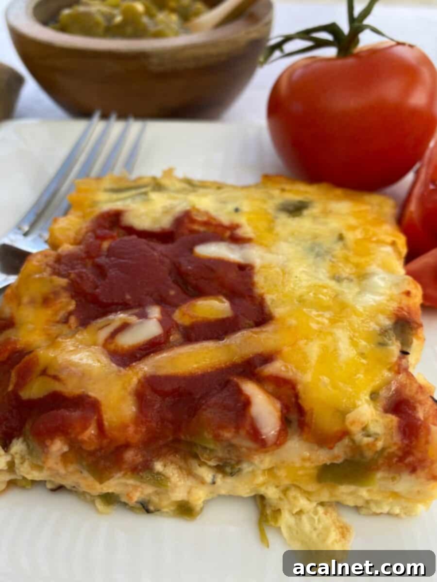 Fiesta Green Chile Egg Casserole 2 Side view of the green chili egg casserole with fresh tomatoes and a bowl of salsa in the background.